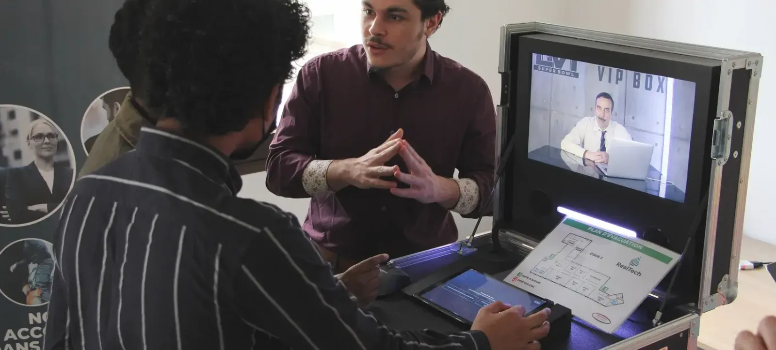 Players around the game case, its screen and tablet