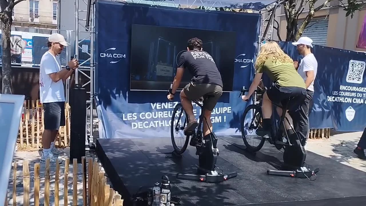 Two players on the bikes, in the fan zone