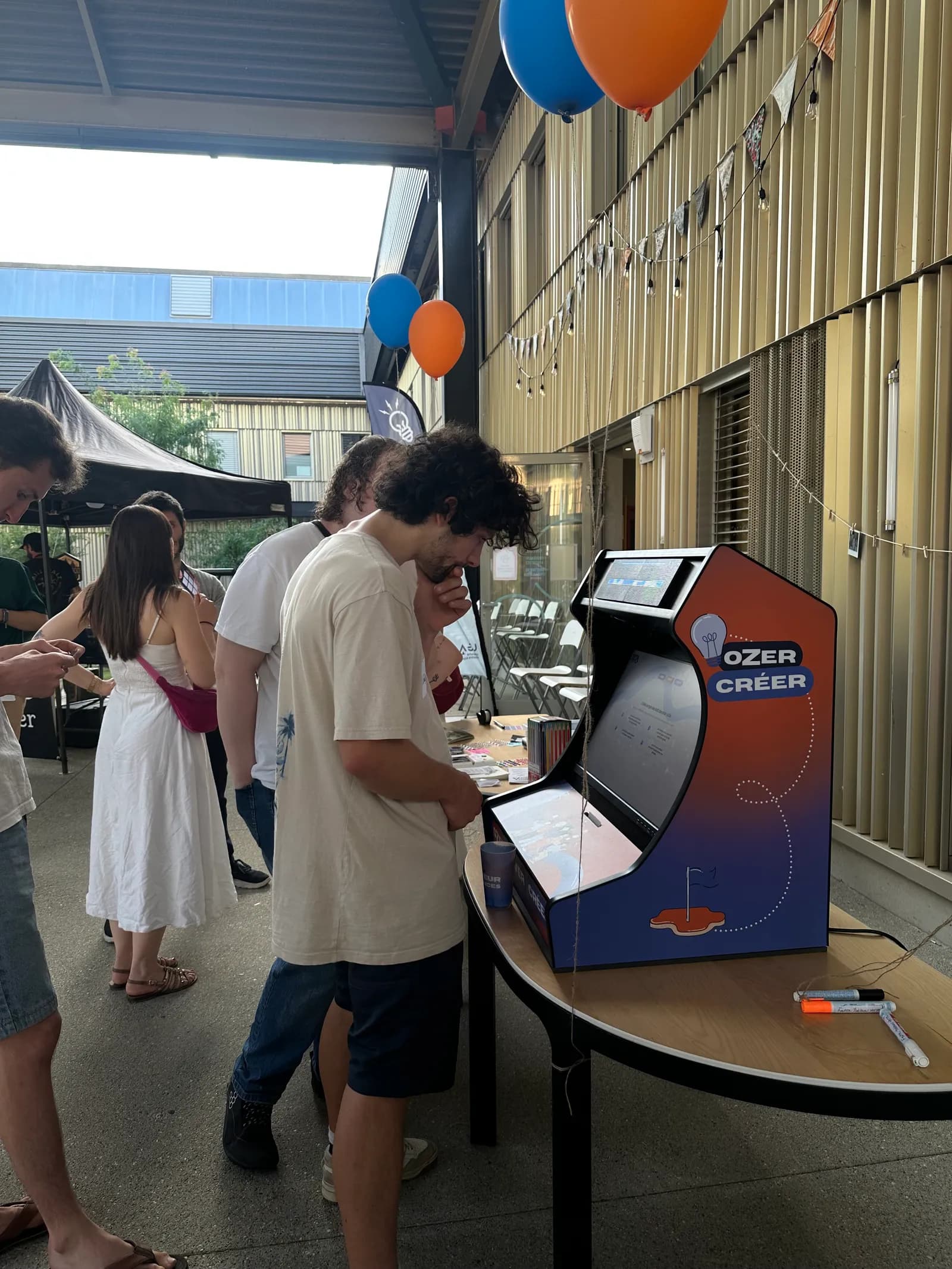 The Ozer arcade kiosk and a player