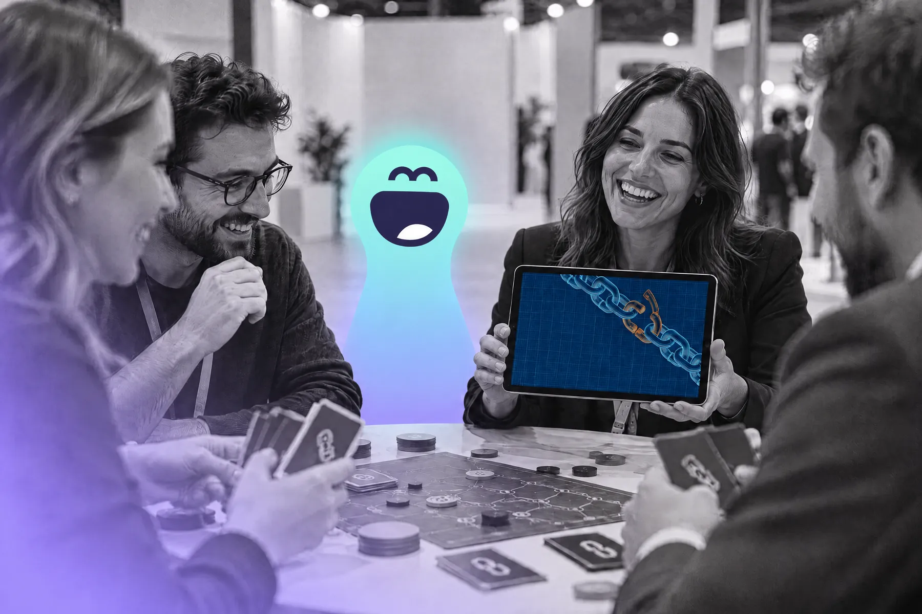 Players around a board and a tablet at a trade show, a Twilie behind the table